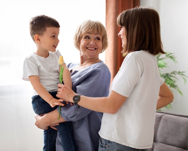 Medium shot happy grandmother holding kid