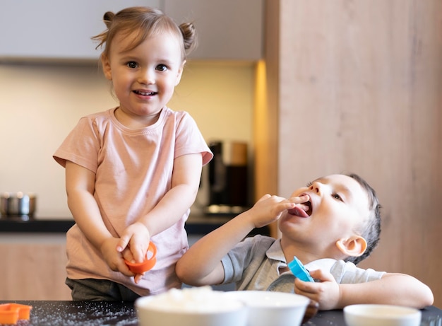 Medium shot happy kids cooking