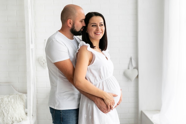 Medium shot husband holding his wife