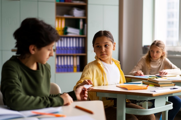 medium shot kids cheating at school