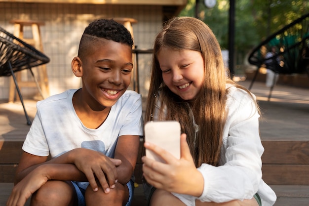 Medium shot kids taking selfie