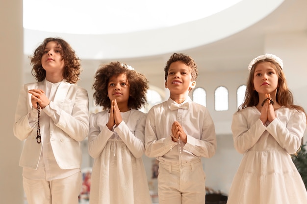 Medium shot latin kids making communion