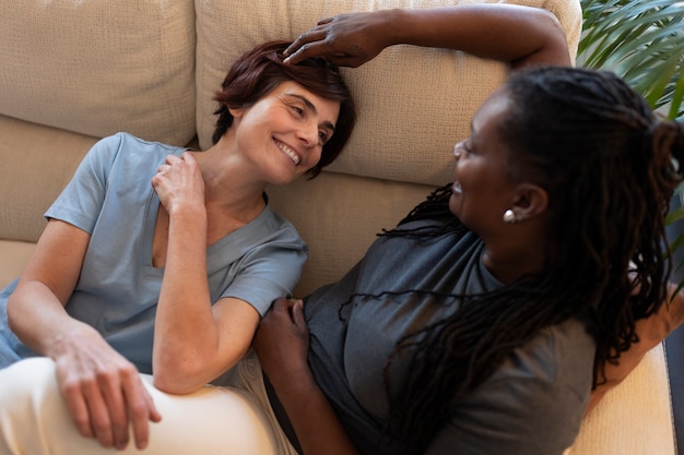 Medium shot lesbian couple at home