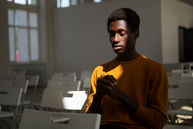 Medium shot man at church praying