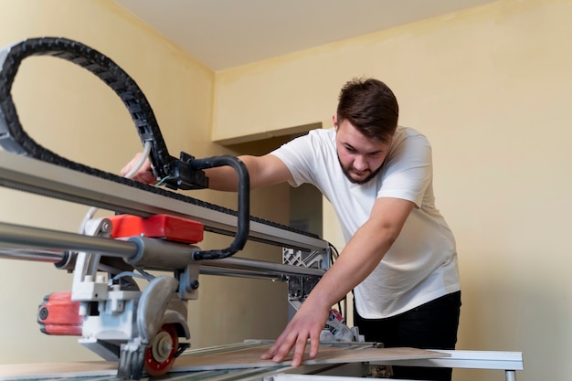 Medium shot man cutting tile