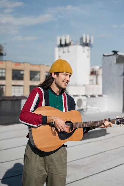 Medium shot man holding guitar