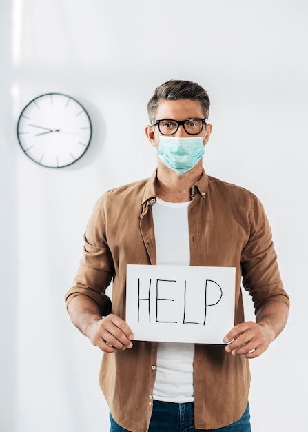 Medium shot man holding help sign