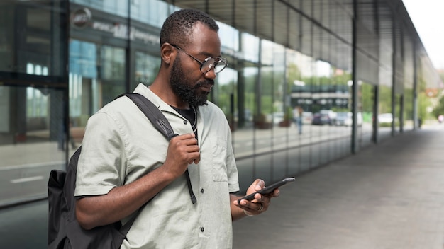 Medium shot man holding phone