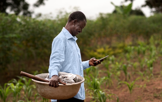 Medium shot man holding smartphone