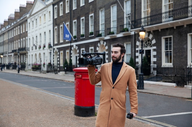 Medium shot man holding video camera