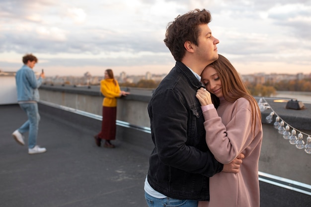 Medium shot man hugging woman