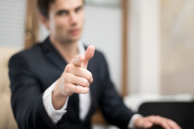 Medium shot of man pointing at camera