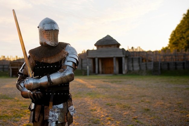 Photo medium shot man posing as a medieval soldier