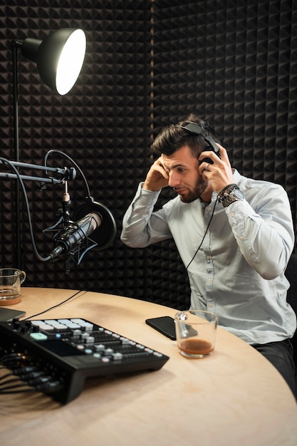 Medium shot man putting on headphones