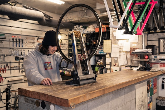 Medium shot man repairing wheel