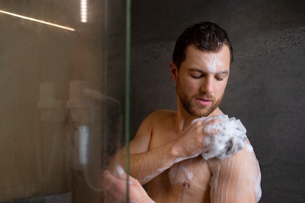 Medium shot man taking shower