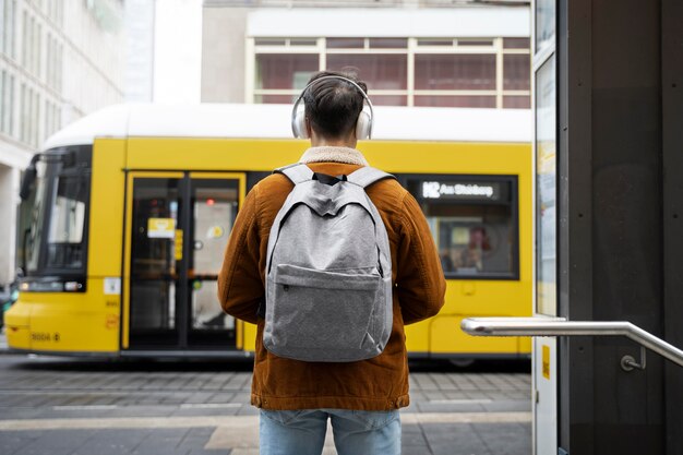 Medium shot man traveling with backpack