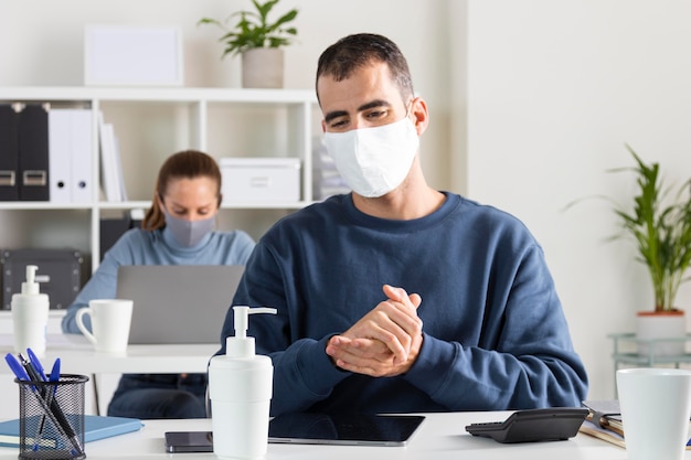 Medium shot man using disinfectant