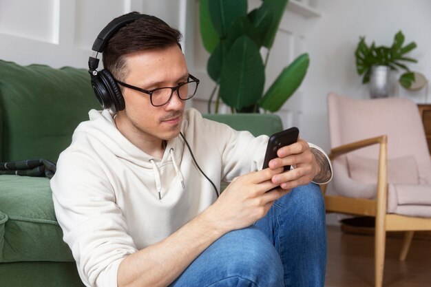 Medium shot man wearing headphones