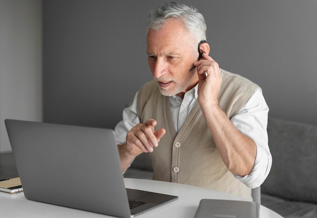 Medium shot man with laptop and earphone