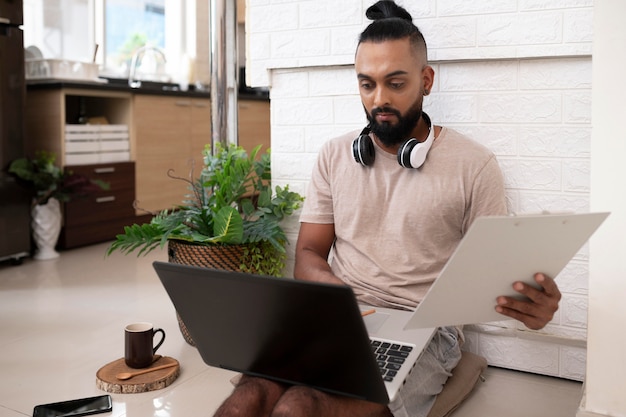 Medium shot man working with laptop