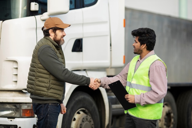 Medium shot men shaking hands