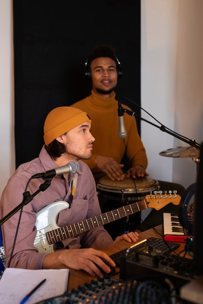 Foto musicisti di tiro medio che lavorano in studio