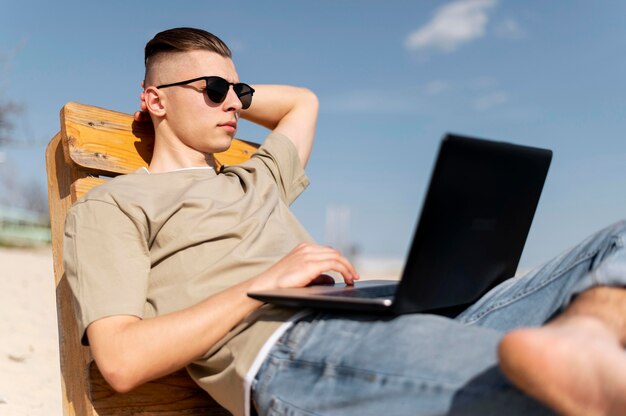 Medium shot nomad man aan het werk op het strand