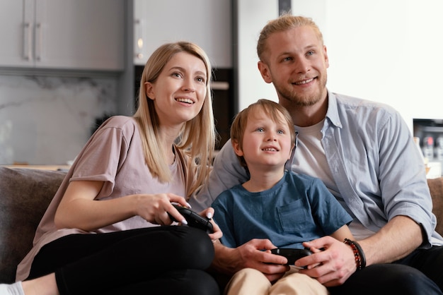 Medium shot parents and kid playing games