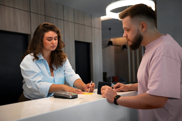 Medium shot plus-size woman working at reception