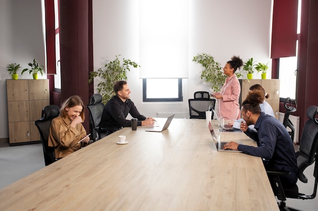 Medium shot pregnant woman at business meeting