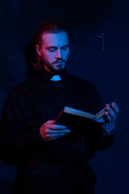 Medium shot priest reading bible