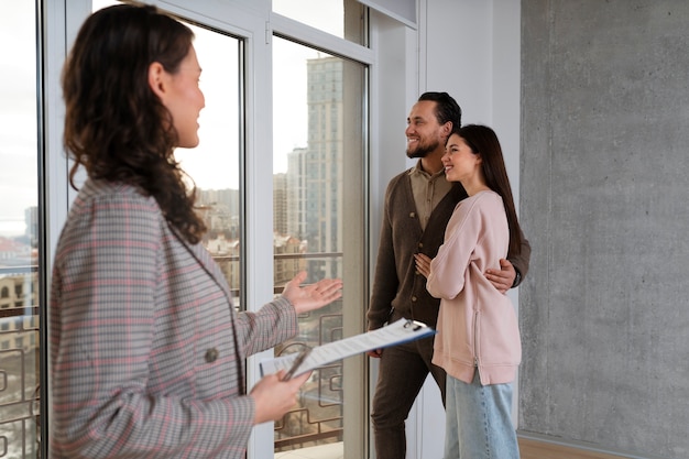 Medium shot real estate agent showing house