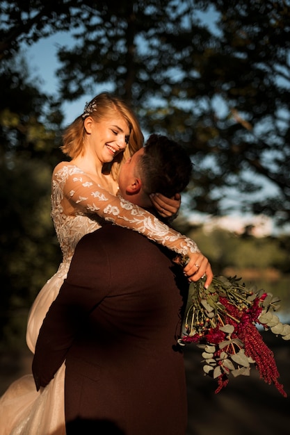 medium shot romantic couple posing outdoors