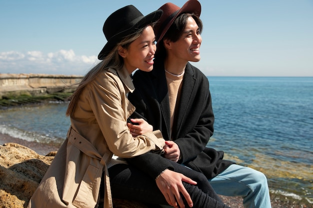 Medium shot romantic couple at seaside