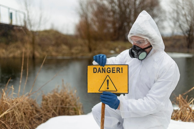 Medium shot scientist holding danger sign