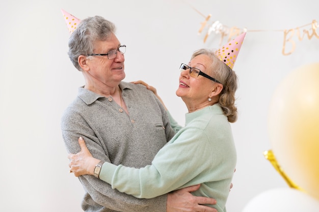 Medium shot senior couple hugging