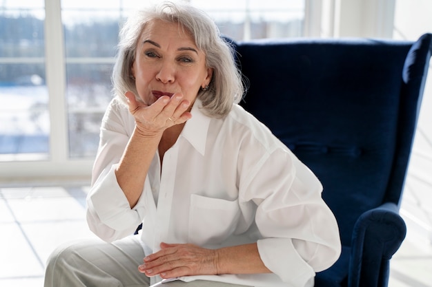 Medium shot senior woman sitting on chair