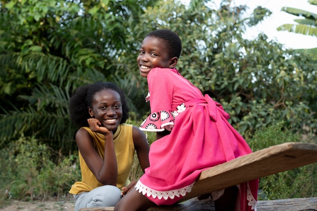 Medium shot smiley african woman and kid