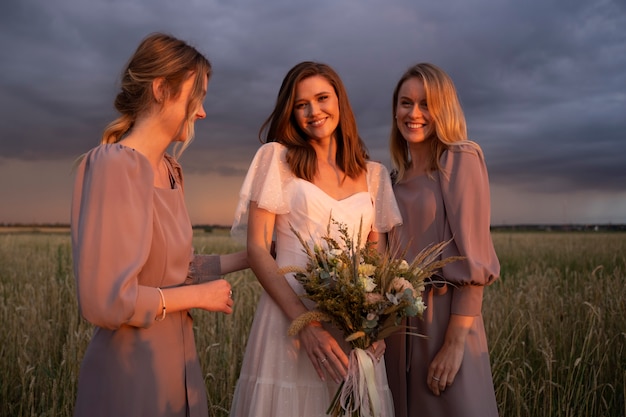 Photo medium shot smiley bride and bridesmaids