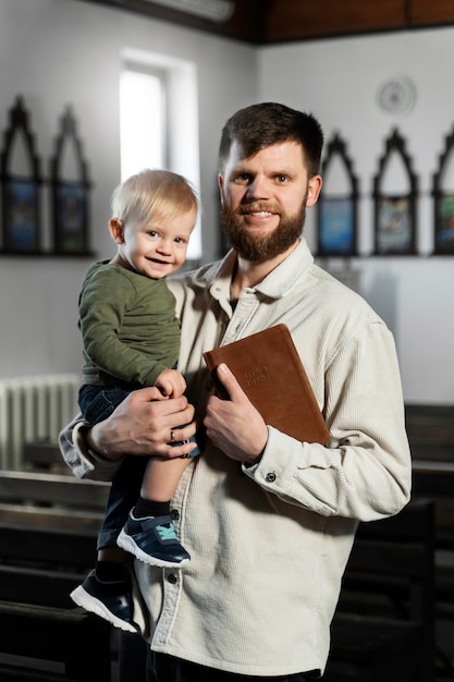 Medium shot smiley christian man and kid