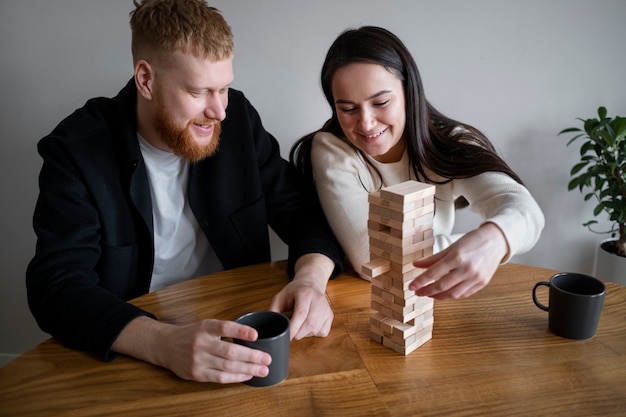 Medium shot smiley couple playing game