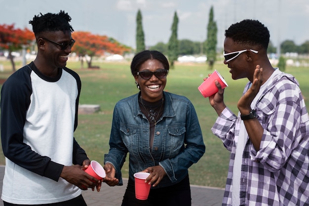 Medium shot smiley friends holding cups