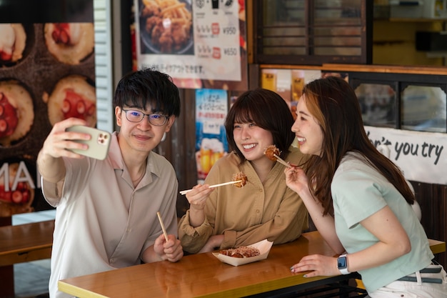 medium shot smiley friends taking selfie