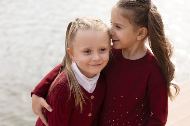 Medium shot smiley girls outdoors