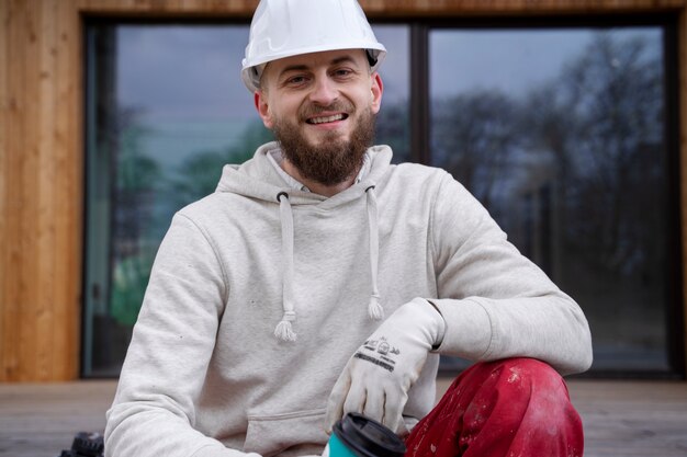 Medium shot smiley man wearing helmet