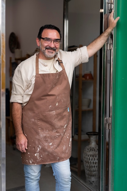 Medium shot smiley man with apron