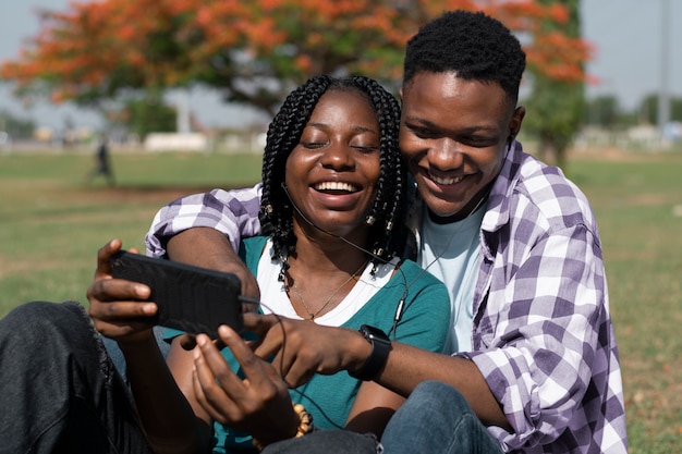 Photo medium shot smiley people with smartphone