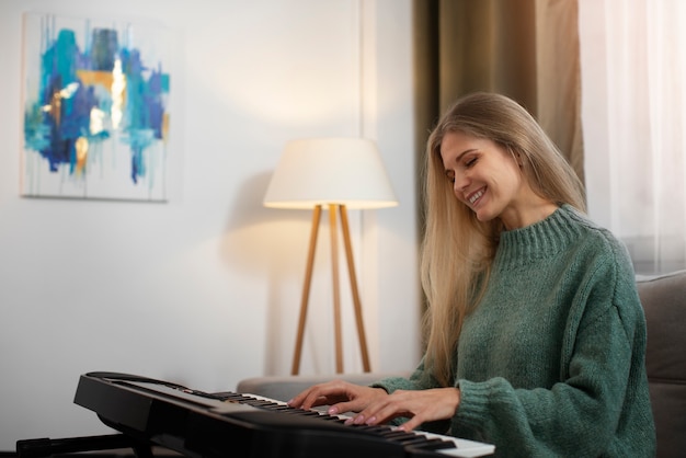 Medium shot smiley woman playing piano