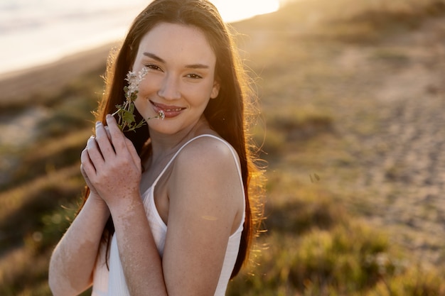 Medium shot smiley woman posing with flowers